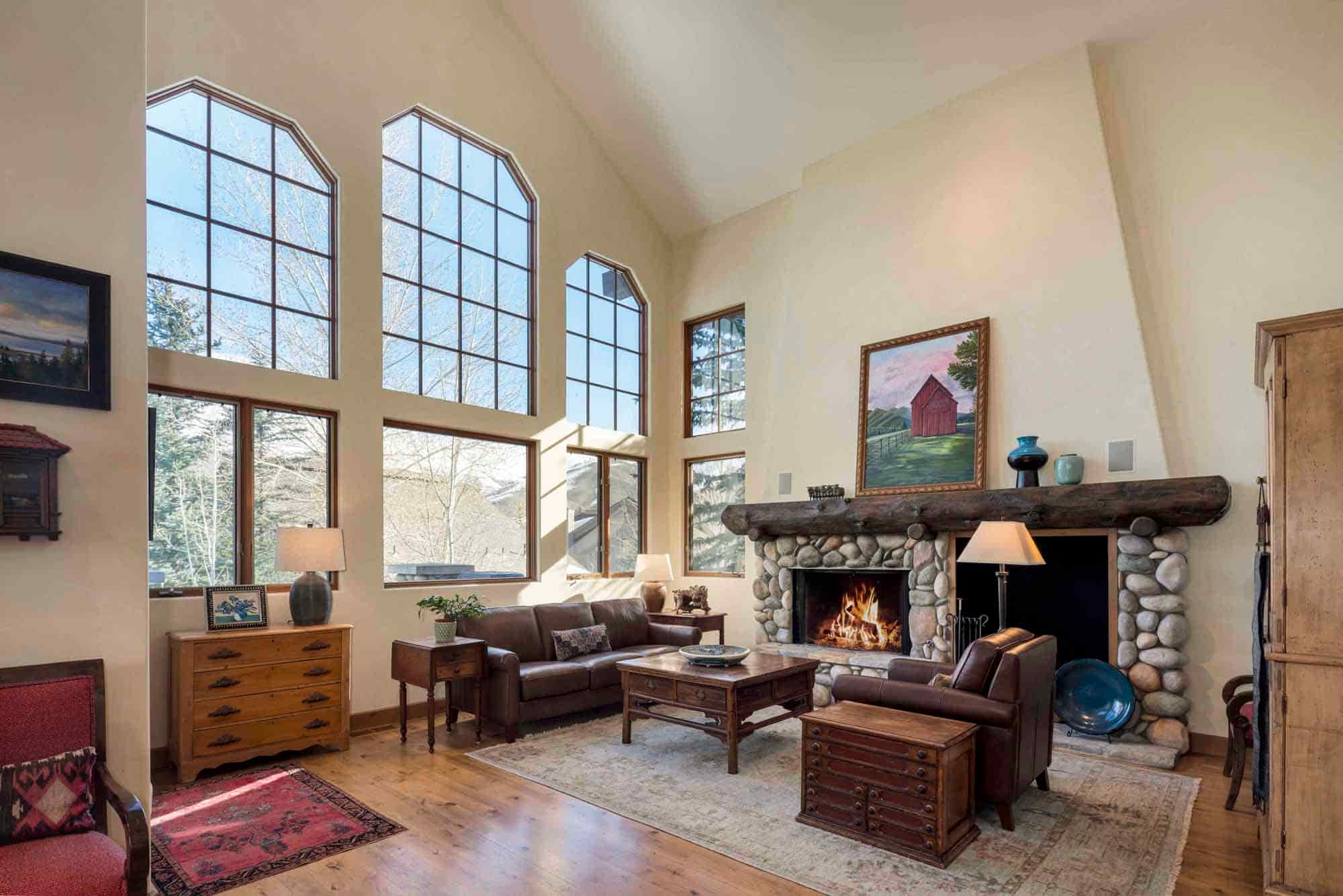The living room's vaulted ceilings and abundant light creates a stunning impression upon entry